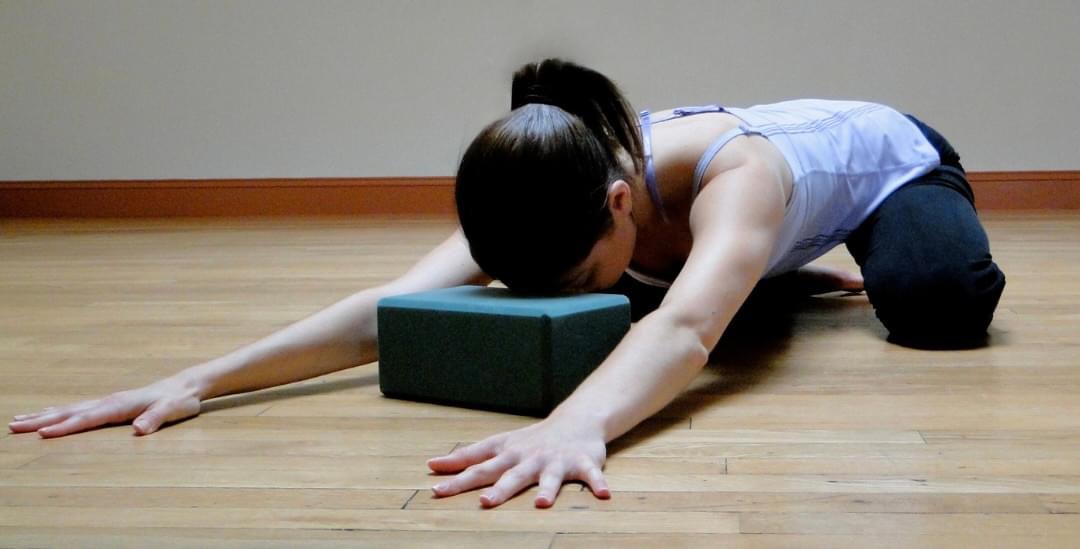 Joanna Barrett in child's pose (yoga)